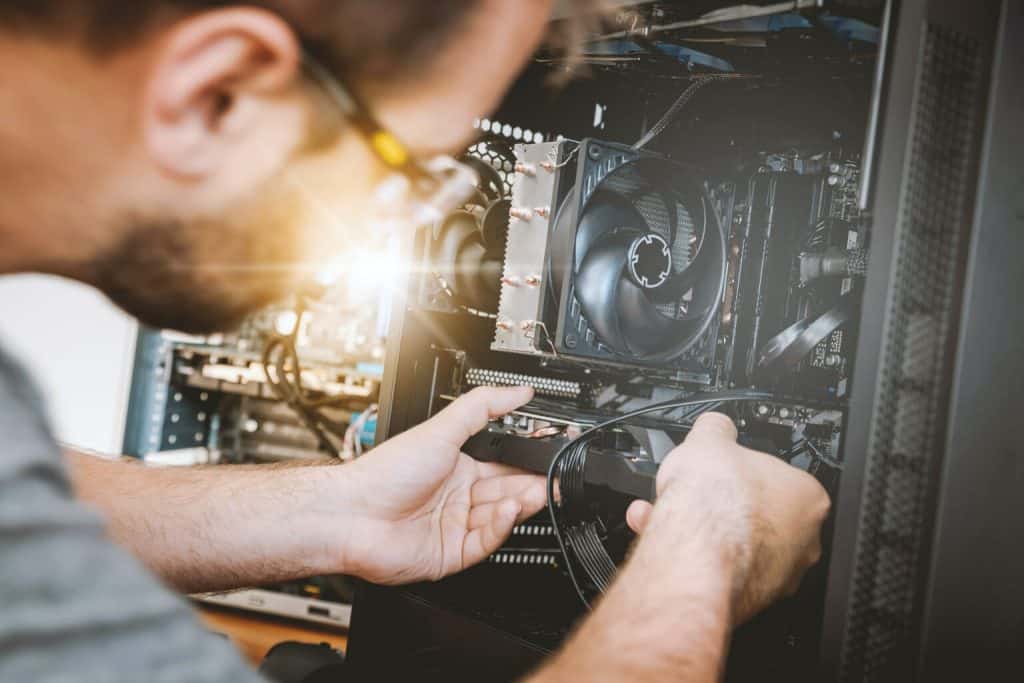 Computer technician upgrading PC hardware