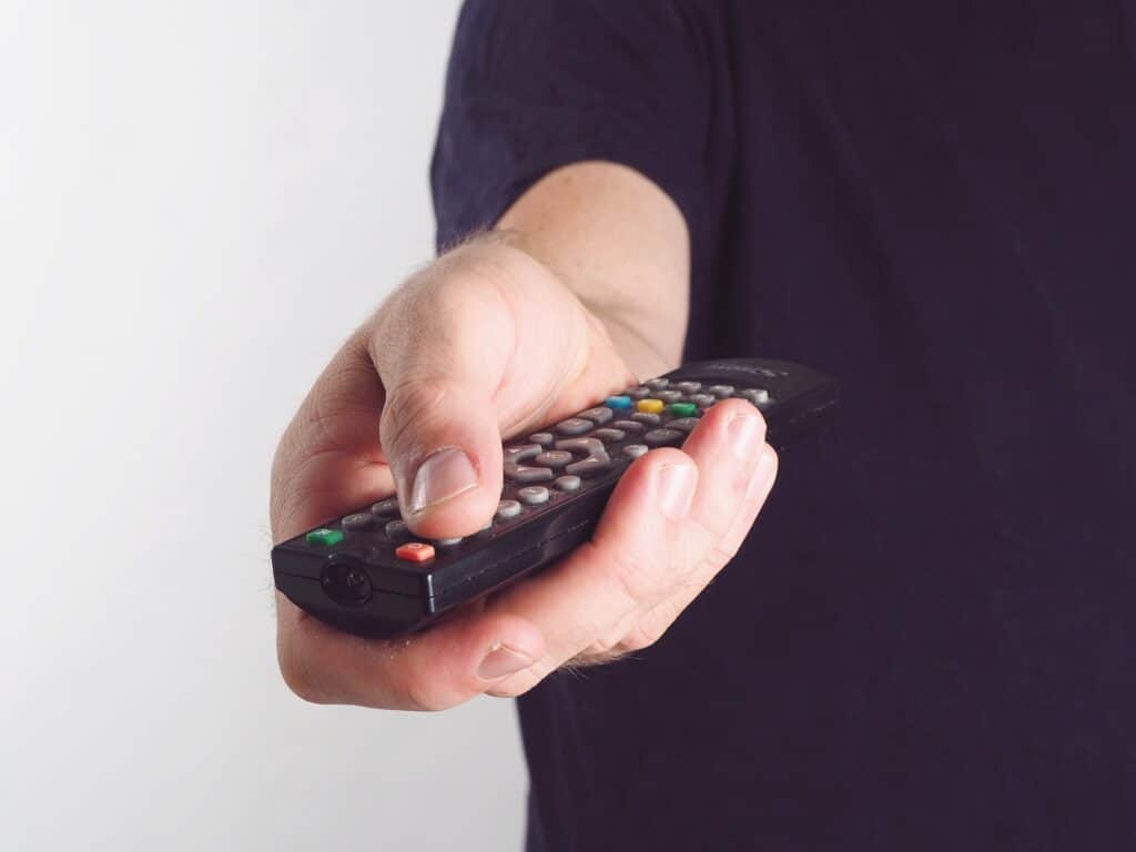 man holding tv remote